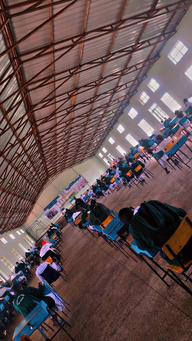 Students sitting an exam in the large school hall