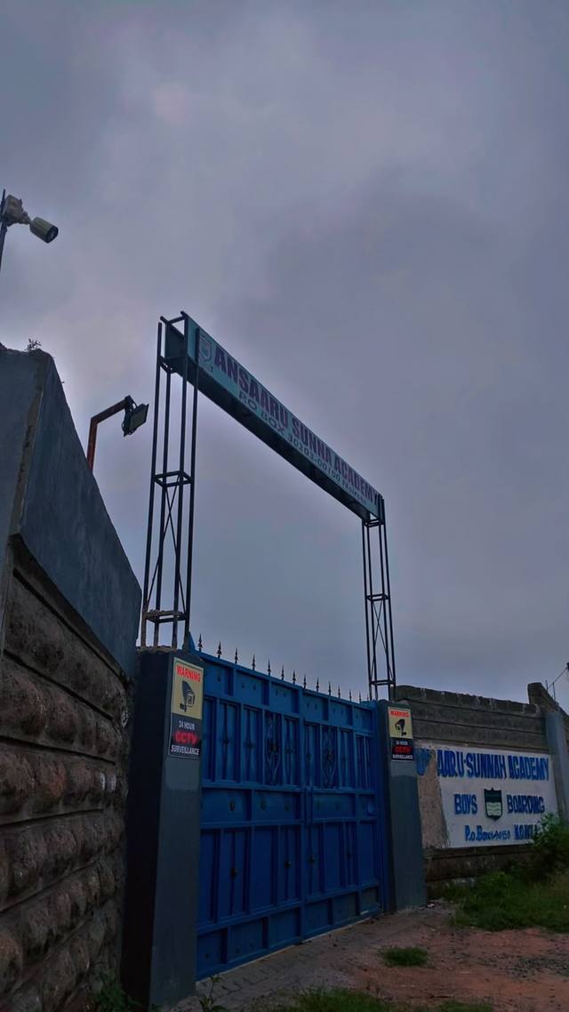 The blue school gate with the Ansaaru Sunna Academy sign above it